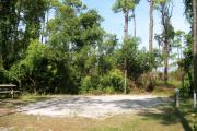 View from the right showing picnic table and ground grill.