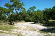 View from the right showing fencing buffering the campsite.
