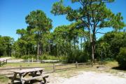 View from the left showing picnic table and ground grill.