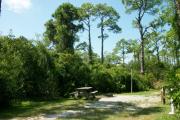 View from the right showing picnic table and ground grill.