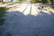 View from the back showing the picnic table in the foreground and other campsites across the street.