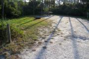 View from the front showing the electrical box on the right and vegetation surrounding the site.