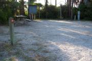 View from the front showing the picnic table on the left and the electrical box and water hookup on the right.