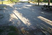 View from the back showing the picnic table in the foreground and other campsites across the street.