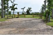 A picnic table, ground grill and clothesline with electric and water in a campsite.
