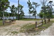 Fence shows the way to this campsite with a view of the lake.