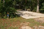 ADA-accessible campsite with concrete pad with electric and water in a campsite with restroom.