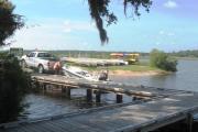 A fisherman launches his boat at the marina at Tomoka State Park, with rental canoe and kayaks in the background, set on the scenic Tomoka River. Campers are welcome to bring their boats, or rent them from the Tomoka Outpost in order to fully experience the rivers, which provide great fishing, recreation, and wildlife viewing opportunities.