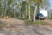 Family playing at the playground facility located within the picnic area. Pavilions are available first come first serve or by reservation with restrooms nearby and easy access to 16 miles of hiking trails.