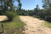 Full view of campsite 2 from road. Electrical and water hookups are located on the right side of the site (not shown).
