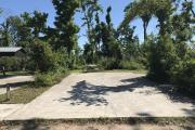 Full view of campsite 8 from road. Electrical and water hookup are located on the right side of the site.