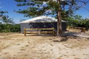 View of front side of Year-round Universal Recreational Tent (YURT) at parking area.