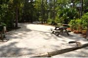 This photo is from the back of the site and shows the campground road.  The fire ring/grill is located in the back corner of the site and the site is surrounded by sections of low, split rail fence.