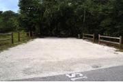 This photo shows Oak trees that border one side and the back of the site and an open area on the other side.