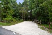 This photo shows the surrounding Oaks and low vegetation around this site and the bathhouse in the background.