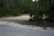 In LOOP 1 #4, a better view of the entrance to the site more palmetto and trees surround the site. Site Marker is on the right side of the main road