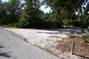 In LOOP 1 #19, a better view of the entrance to the site more palmetto and trees surround the site. Site Marker is on the right side of the main road