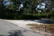 In LOOP 1 #10, a better view of the entrance to the site more palmetto and trees surround the site. Site Marker is on the right side of the main road