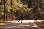 A bicyclist and rollerblader enjoy the Gainesville-Hawthorne trail.  This 16 mile long, paved Rails-to-Trails trail is popular with bicyclists, pedestrians, and equestrians.Ã¢ÂÂ