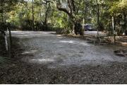 A September view of the campground drive from within campsite #12.  The water hookup is seen on the left.  Campsite #13 is visible across the campground drive, and campsite #14 is visible through the woods to the right.  Site is surrounded on three sides by a mixed oak, pine, and cabbage palm forest.