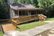 Cabin #2 at Blue Spring State Park showing an ADA accessible picnic table on the front screen-porch.