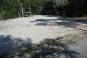 A view of the campsite with a shell/sand base and native vegetation.