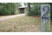 This view of cabin site marker is for cabin number 2. Also pictured is the walkway up to the cabin as viewed from the three space parking lot.