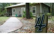 This view of cabin site marker is for cabin number 4. Also pictured is the walkway up to the cabin as viewed from the three space parking lot.