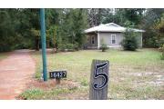 This view of cabin site marker is for cabin number 5. Also pictured is the walkway up to the cabin as viewed from the three space parking lot. The plaque with the 5 digits (16427) is the street identifier and not the cabin number. Although cabin 5 has a similar layout of cabins 1-4, it is an ADA cabin.