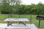 Photo: 001, PRIM. Cabin #1 at Oleta River has a picnic table and a barbeque grill.