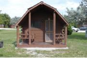 Photo: 002, PRIM. Cabin #2 at Oleta River has a porch swing and a barbeque grill.