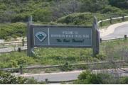 Henderson Beach State Park entrance sign in an island along the main park drive.