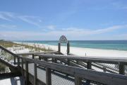 Beach access on a beautiful day with emerald water and blue skis at Henderson Beach State Park