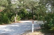 Sign for site #24 with picnic table and clothes line.