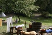 This photo shows an interpretive display showing Visitors the equipment used to wash clothes in the 1800âs. There are clothes, wooden benches, and wash barrels pictured. Rainbow has many educational events throughout the year.