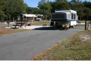 This site has a standing grill, fire ring, picnic table, water, electric 20/30/50 amp, and sewer. Amenities include a campground store, recreation hall, ADA accessible showers and restrooms, laundry, dump station, canoe rentals, short walk to the river, and playground. Maximum RV length is 40 ft. This is a paved ADA accessible site.