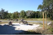 This site has a standing grill, fire ring, picnic table, water, electric 20/30/50 amp, and sewer. Amenities include a camp store, recreation hall, ADA accessible showers and restrooms, laundry, dump station, canoe rentals, short walk to the river, and playground. Tents and RV (maximum length of 40 ft) are allowed. This site is fine gravel surface.