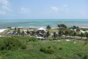 Photo: CURRY HAMMOCK SP. A birdâs eye view of the day use area at Curry Hammock State Park including the picnic pavilions, parking lot, bath house and the shallow waters offshore of the beach.