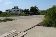 Photo: 002, View looking out from picnic table to campground road, RV in background.