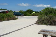 Photo: 009, View looking out from back of site to campground road. Truck & tent in background.