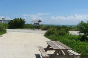 Photo: 014, View looking out from back of site to campground road. . Kiosk and beach access in background.