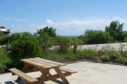 Photo: 020, View looking out from back of site to beach, Atlantic Ocean and bushes in background.