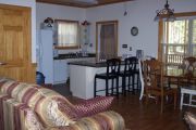 As an ADA cabin some alterations have been made to make the unit more user friendly. Otherwise the interior is pretty much the same as the other cabins. The main living area of the cabins offers two comfortable couches, and a wooden dining table with four wood chairs. An electric fireplace can be operated year round and can give off heat or be set so you can just watch the flames flicker. In the modern kitchen there is a dish washer, micro wave oven, stove, big refrigerator and an automatic coffee maker. Not seen are the two bedrooms and bathroom.