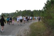 5K race participants staring their run down Topsail Hill State Parkâs paved tram path.
