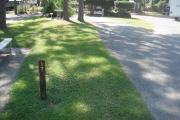 A view of RV site seventeen at Topsail Hill Preserve State Park showing the site marker, a picnic table to the left of the site, and utility hook up boxes to the right.