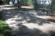 A view of RV site twenty-nine at Topsail Hill Preserve State Park looking towards the front of the site.  A picnic table is on a concrete pad to the right of the site.  Neighboring RVs can be seen in the background.