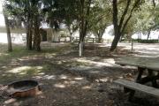 An ADA accessible picnic table and straight handled water valve help provide a camping experience for all.