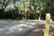 Mostly sunny campsite 7 has a wide vehicle pad and entrance.
