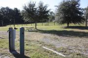 Photo: 2, ROSS PRAIRIE. View of campsite wtih water and electric hookups. A picnic table and fire ring can be seen.
