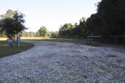 Photo: 4, ROSS PRAIRIE. View of campsite with water and electric hookups. A picnic table and fire ring can be seen.